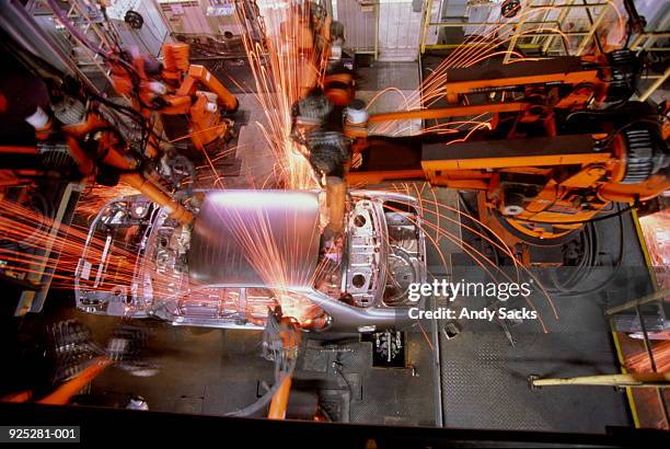 car assembly line, robotic welding on car body, overhead view - domestic car fotografías e imágenes de stock