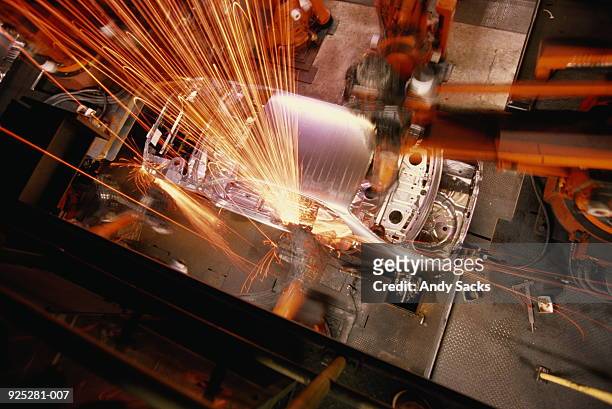 car assembly line,overhead view of robotic welding on car body - auto bauen stock-fotos und bilder