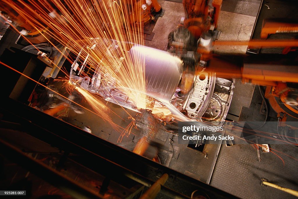Car assembly line,overhead view of robotic welding on car body
