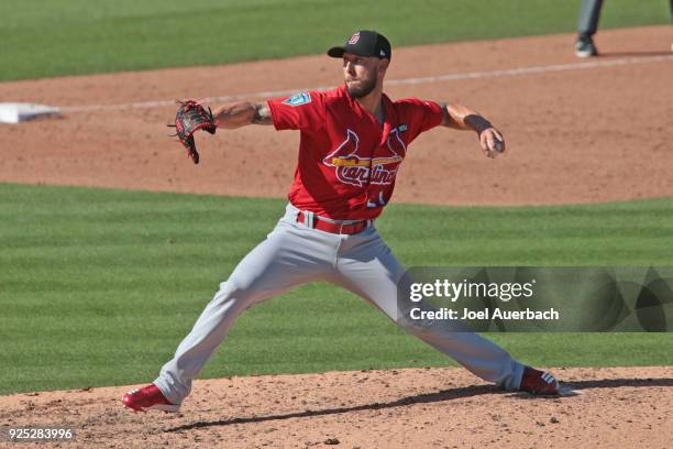 Jordan Schafer of the St Louis Cardinals throws the ball against the Miami Marlins during a spring training game at Roger Dean Chevrolet Stadium on...