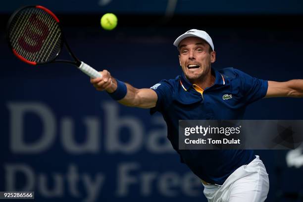 Roberto Bautista Agut of Spain plays a forehand during his match against Pierre-Hugues Herbert of France on day three of the ATP Dubai Duty Free...