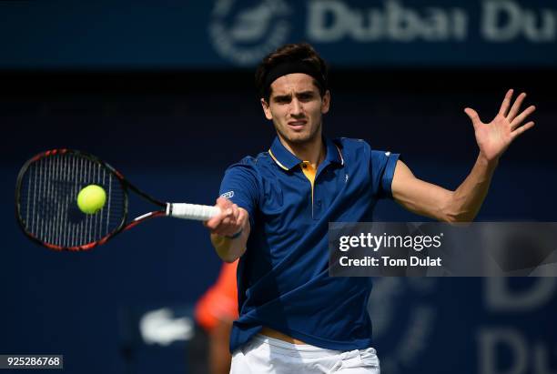 Pierre-Hugues Herbert of France plays a forehand during his match against Roberto Bautista Agut of Spain on day three of the ATP Dubai Duty Free...