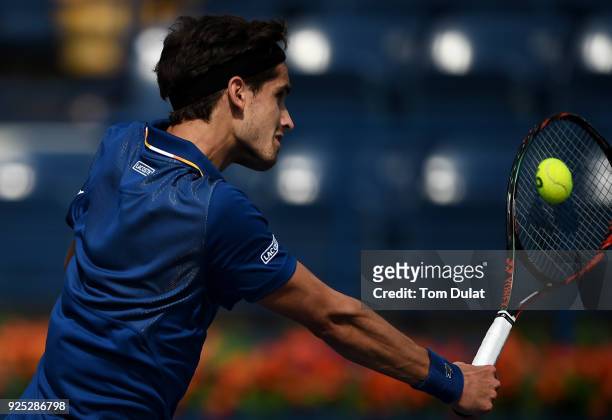 Pierre-Hugues Herbert of France plays a backhand during his match against Roberto Bautista Agut of Spain on day three of the ATP Dubai Duty Free...