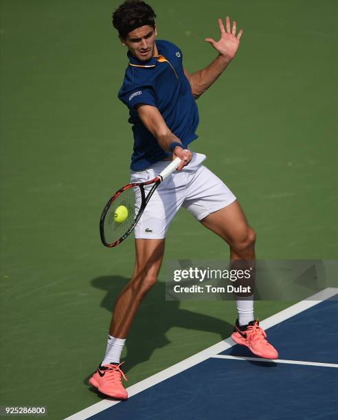 Pierre-Hugues Herbert of France plays a forehand during his match against Roberto Bautista Agut of Spain on day three of the ATP Dubai Duty Free...