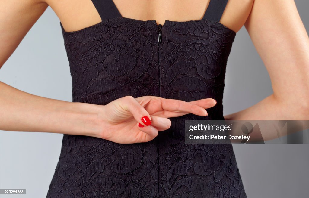 FINGERS CROSSED BEHIND BACK FOR GOOD LUCK