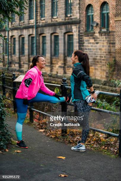 Two Woman Prepare To Run By Stretching