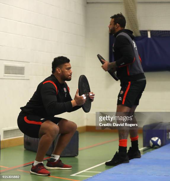 Nathan Huhges stretches with team mate Courtney Lawes during the England conditioning session held at Nuffield Health Centre on February 28, 2018 in...