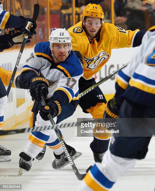Jaden Schwartz of the St. Louis Blues skates against Calle Jarnkrok of the Nashville Predators during an NHL game at Bridgestone Arena on February...