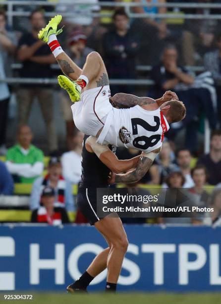 Tim Membrey of the Saints flies over Caleb Marchbank of the Blues during the AFL 2018 JLT Community Series match between the Carlton Blues and the St...