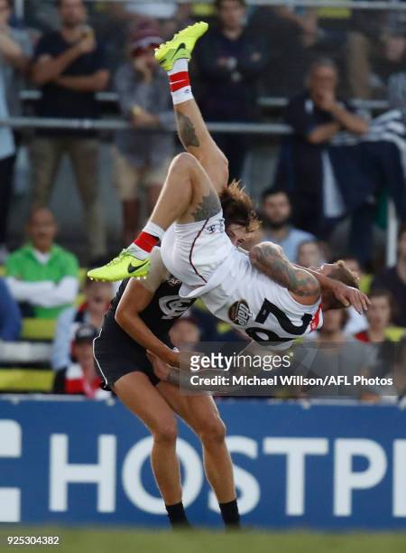Tim Membrey of the Saints flies over Caleb Marchbank of the Blues during the AFL 2018 JLT Community Series match between the Carlton Blues and the St...