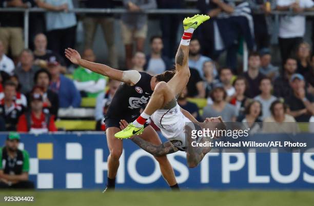 Tim Membrey of the Saints flies over Caleb Marchbank of the Blues during the AFL 2018 JLT Community Series match between the Carlton Blues and the St...