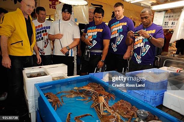 Tokyo restauranter Andy Lunt shows Wayne Smith, Cory Flynn, Tanerau Latimer, Wyatt Crockett and Sitiveni Sivivatu of New Zealand All Blacks around...