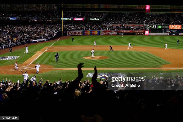 Mark Teixeira of the New York Yankees rounds the bases after hitting a solo home run in the fourth inning against the Philadelphia Phillies in Game...