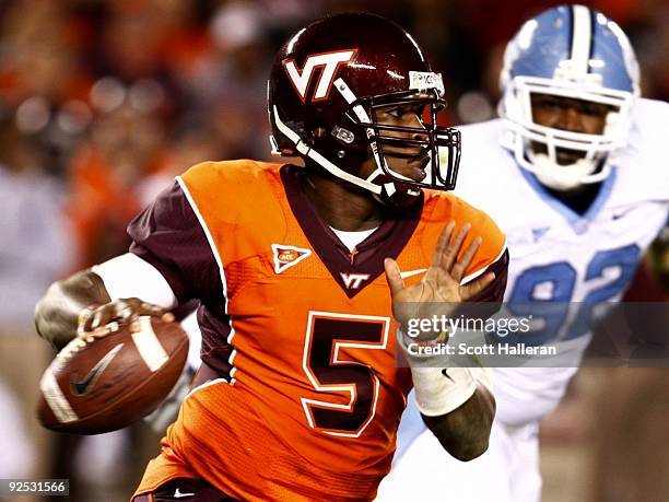 Quarterback Tyrod Taylor of the Virginia Tech University Hokies looks to pass the ball against E.J. Wilson of the North Carolina Tar Heels during the...