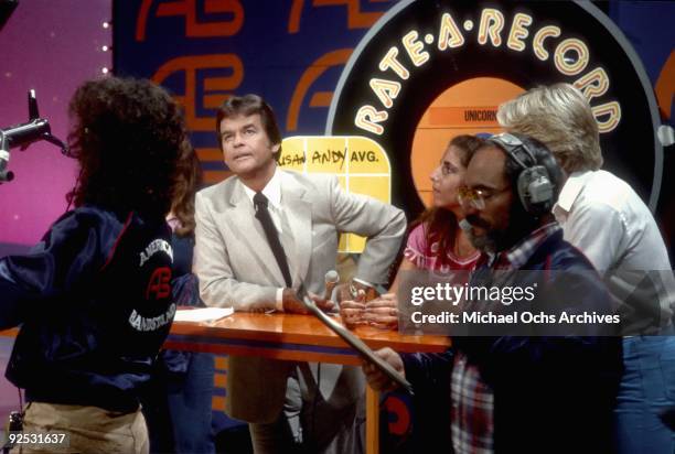 Host of the television series 'American Bandstand' Dick Clark asks members of the studio audience their opinions on a new release in 1980 in Los...