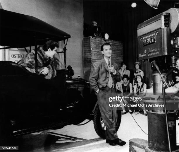 Television host Dick Clark interviews teen idol Paul Anka on the set of his show 'American Bandstand' in October 1960 in Philadelphia, Pennsylvania.