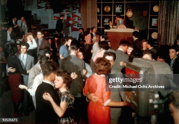 Television host Dick Clark presides over the set of his show 'American Bandstand' as teenagers dance to top 40 popular music circa 1957 in...