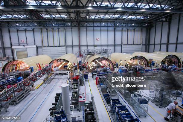 The fuselages of Airbus A350 twin-engine wide-body jet airliners sit on the Airbus SE aircraft assembly line in Hamburg, Germany, on Tuesday, Feb....