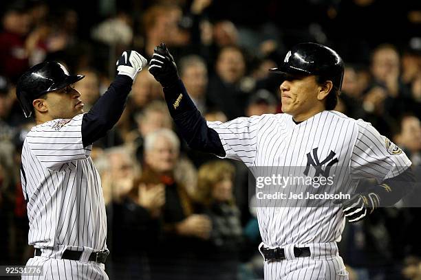 Hideki Matsui of the New York Yankees celebrates with Jerry Hairston Jr. #17 after hitting a solo home run in the sixth inning against the...