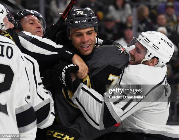 Ryan Reaves of the Vegas Golden Knights is grabbed by linesman Jonny Murray and Torrey Mitchell of the Los Angeles Kings during a scuffle in the...