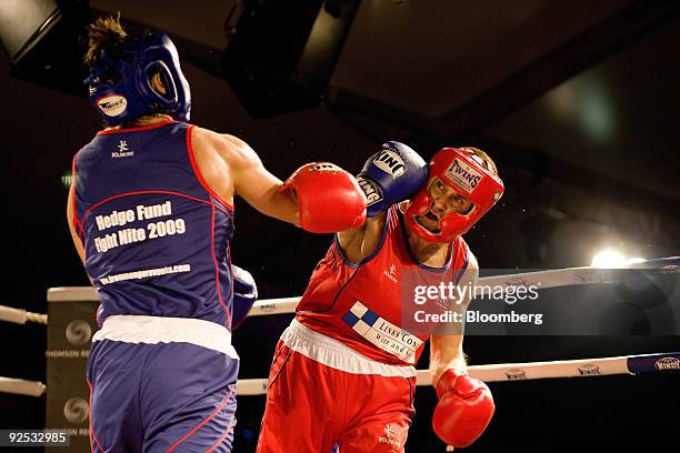 John "Headcount Reduction" Crane of 3A Asia, right, exchanges blows with Justin "Carve 'em Up" Jones of Link - ICAP, in second round action, during...