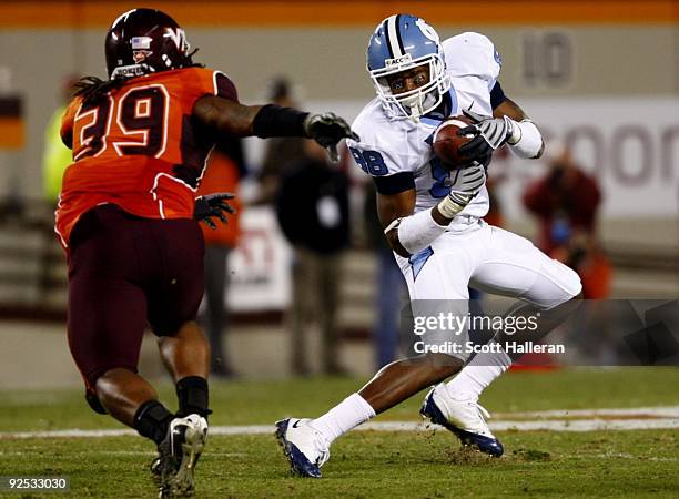 Wide receiver Erik Highsmith of the North Carolina Tar Heels makes a catch in front of Lyndell Gibson of the Virginia Tech University Hokies during...