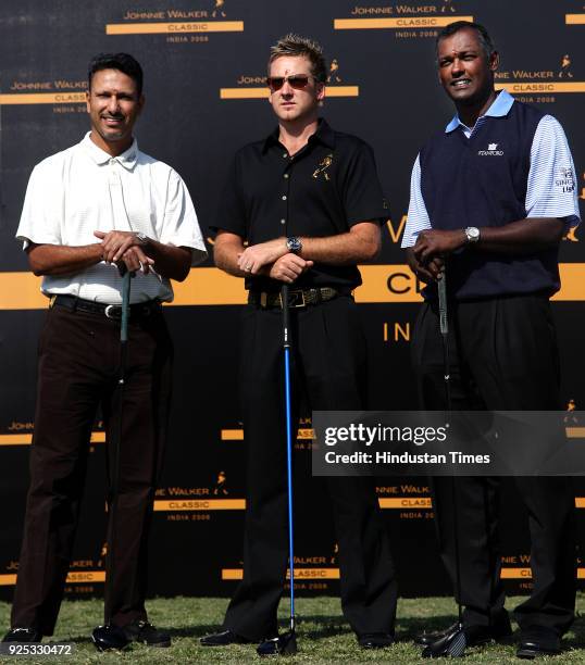 British golfer Ian Poulter , Vijay Singh of Fiji and India's Jeev Milkha Singh pose for a photograph during a welcoming ceremony ahead of the Johnnie...