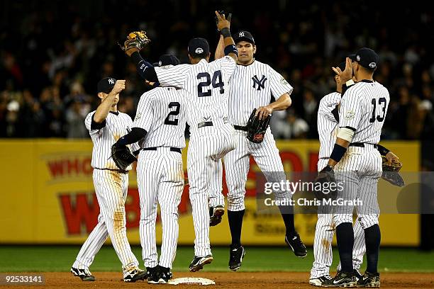 Johnny Damon of the New York Yankees celebrates with Robinson Cano and Alex Rodriguez after defeating the Philadelphia Phillies two win Game Two of...