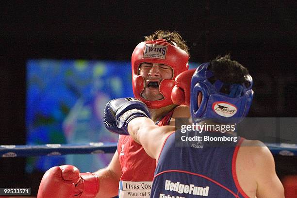 James "Bada Bing" Bryan of Execuzen, left, exchanges blows with Terry "The Eastern Southpaw" Koon of Zurich International, in second round action,...