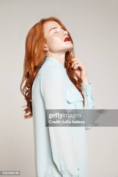 redhead woman in blue blouse - blouse back stock pictures, royalty-free photos & images