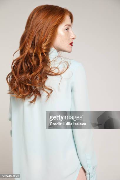 redhead woman in blue blouse - three quarter length stock pictures, royalty-free photos & images