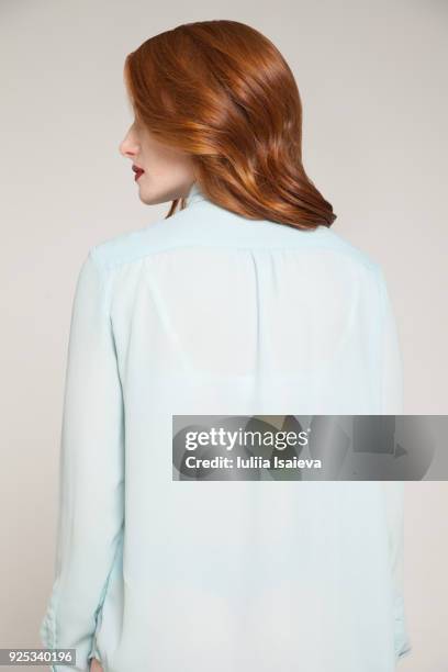 redhead woman in blue blouse - grey blouse stock pictures, royalty-free photos & images