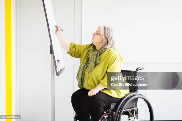 woman in wheelchair working in office