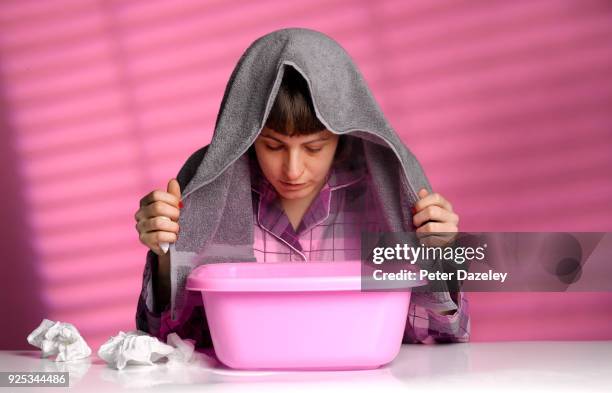 woman with cold/flu inhaling steam from a bowl - cold virus stock pictures, royalty-free photos & images