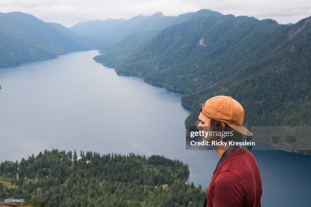 Man Looks Over FjordFrom Mountain