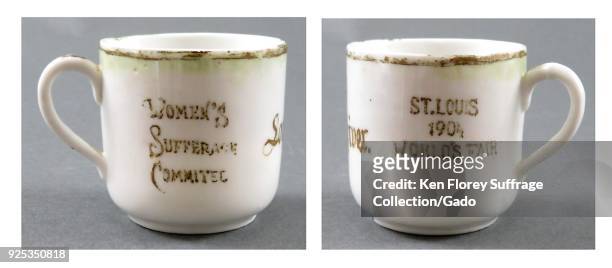 Small, china teacup, white, with brown or dark green text reading on one side 'St Louis 1904 World's Fair,' and the word suffrage intentionally...