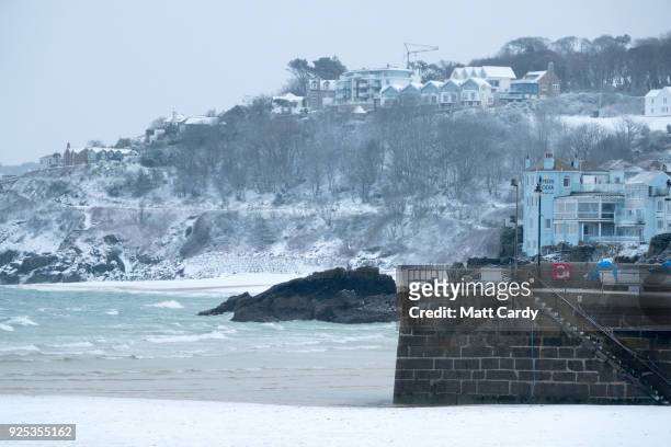 Snow covers the cliffs surrounding Carbis Bay as snow arrives in St Ives on February 28, 2018 in Cornwall, England. Freezing weather conditions...