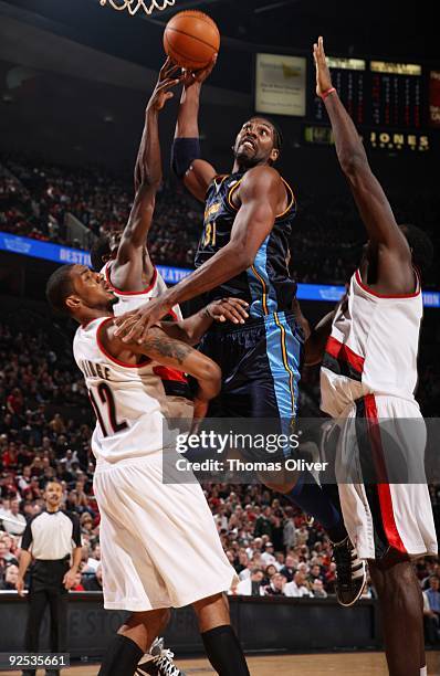 Nene of the Denver Nuggets goes up for a dunk over LaMarcus Aldridge of the Portland Trail Blazers during a game on October 29, 2009 at the Rose...