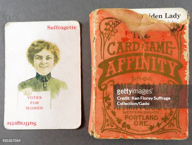 Box and card from the educational game "Affinity, " card at left depicts a young woman holding a paper with the text "VOTES FOR WOMEN, " and is...