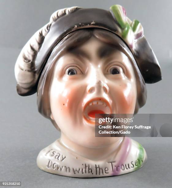 Ceramic tobacco jar, with a removable hat, depicting a suffragette wearing the purple, green, and white colors of the militant Women's Political and...