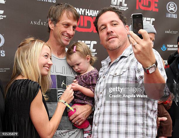 Lhotse Merriam, Tony Hawk, their daughter Kadence Clover Hawk and Jon Favreau arrive to the 'Tony Hawk: Ride Presents Stand Up For Skateparks'...