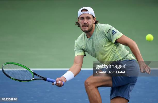 Lucas Pouille of France returns a shot during his match against Karen Khachanov of Russia on day three of the ATP Dubai Duty Free Tennis...