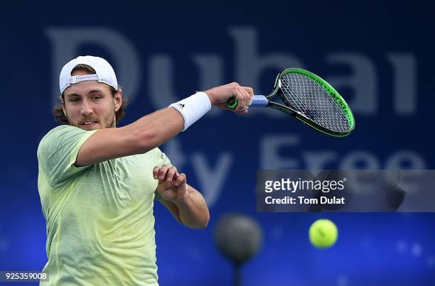 Lucas Pouille of France returns a shot during his match against Karen Khachanov of Russia on day three of the ATP Dubai Duty Free Tennis...
