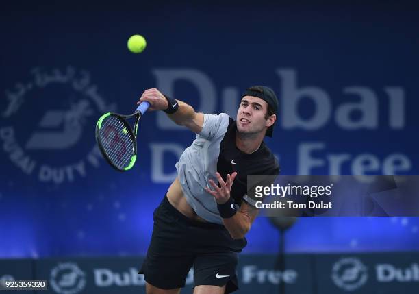 Karen Khachanov of Russia serves during his match against Lucas Pouille of France on day three of the ATP Dubai Duty Free Tennis Championships at the...