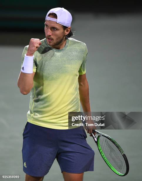 Lucas Pouille of France celebrates winning his match against Karen Khachanov of Russia on day three of the ATP Dubai Duty Free Tennis Championships...