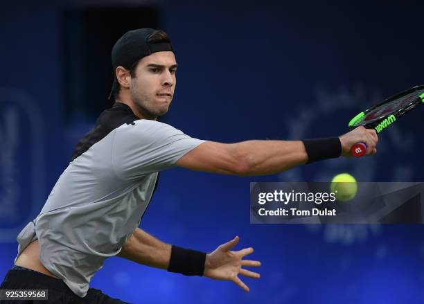 Karen Khachanov of Russia plays a backhand during his match against Lucas Pouille of France on day three of the ATP Dubai Duty Free Tennis...