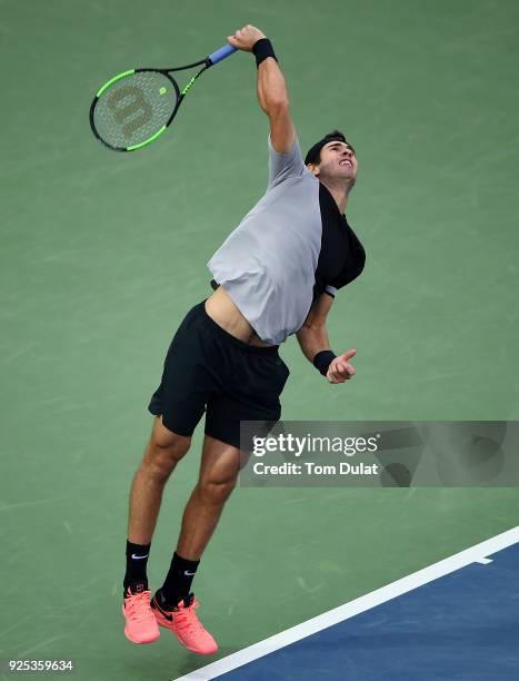 Karen Khachanov of Russia serves during his match against Lucas Pouille of France on day three of the ATP Dubai Duty Free Tennis Championships at the...