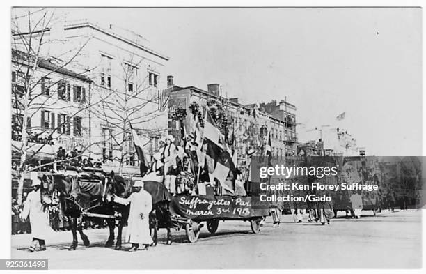 Black and white photograph, likely a postcard, depicting a suffrage parade, that took place on the streets of Washington DC on March 3 the day...