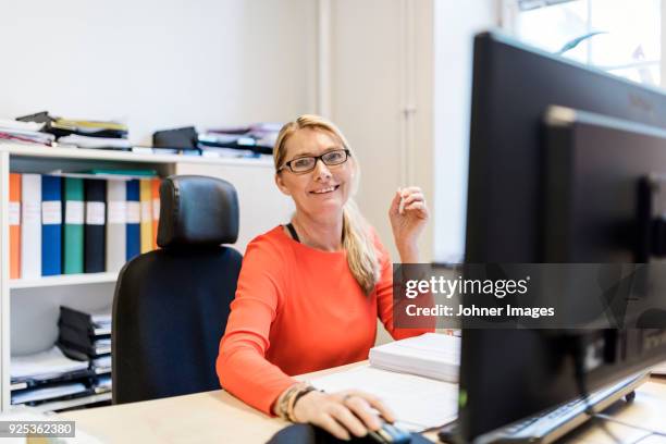 blond woman working in office - large office reception stock pictures, royalty-free photos & images