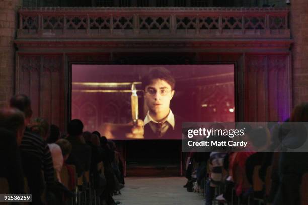 People sit between the 11th century Norman columns in the Romanesque nave as a projectionist shows the film Harry Potter and the Half-Blood Prince on...